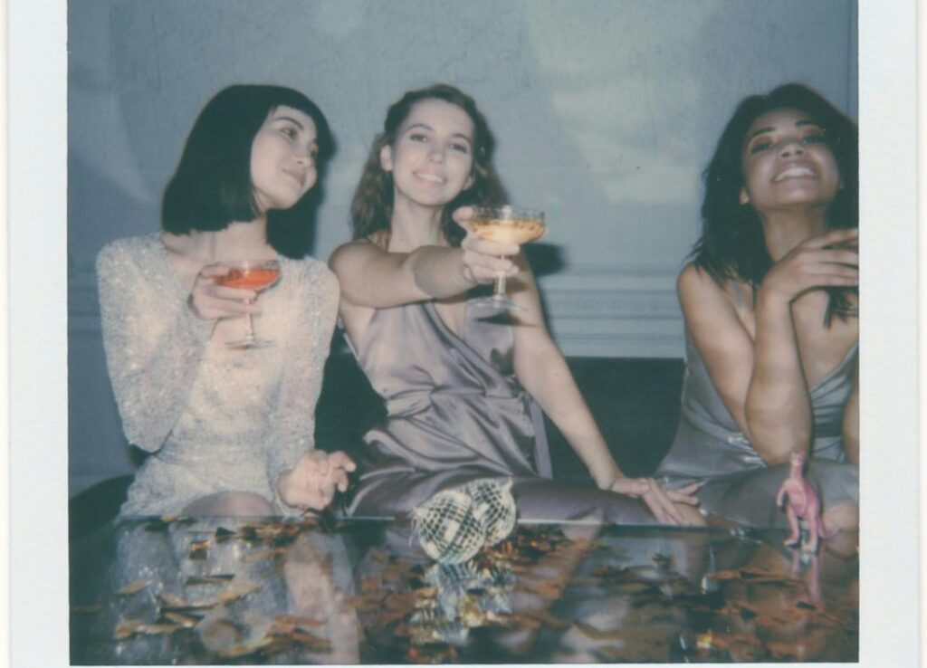 instant photo of three women drinking