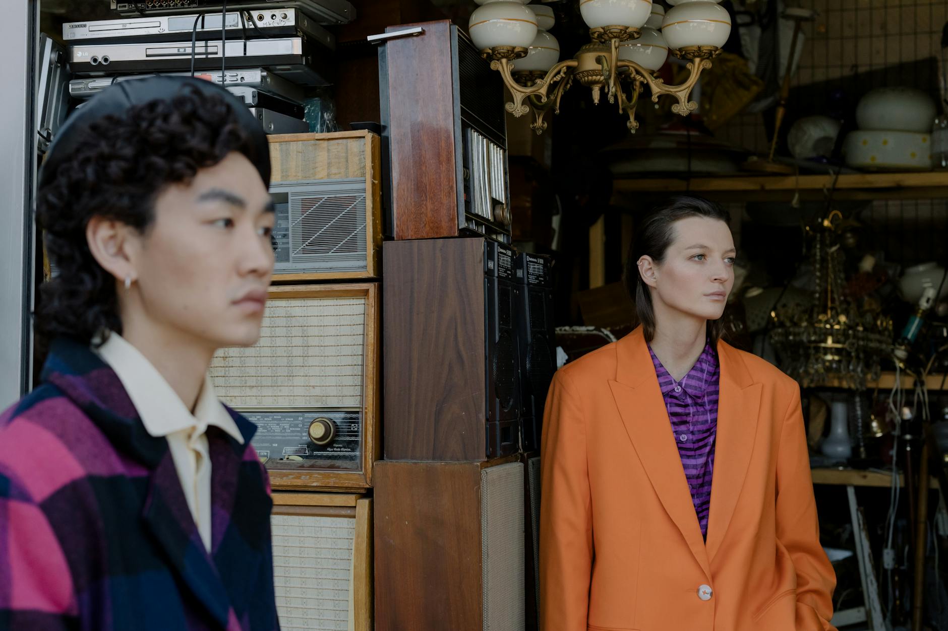 a woman in orange suit jacket standing in a store